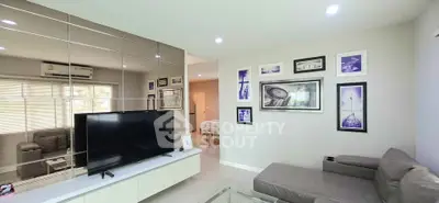 Modern living room with sleek TV setup and stylish wall art