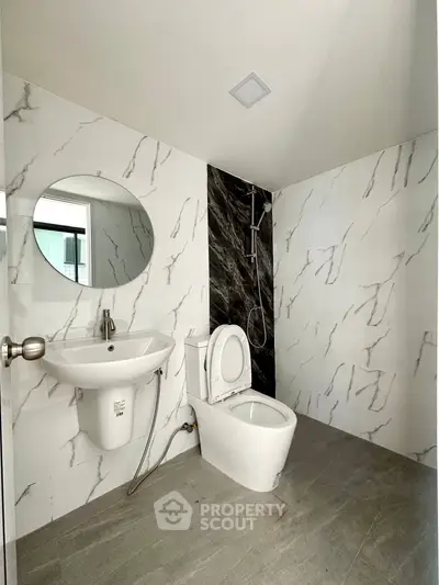Modern bathroom with marble walls and sleek fixtures