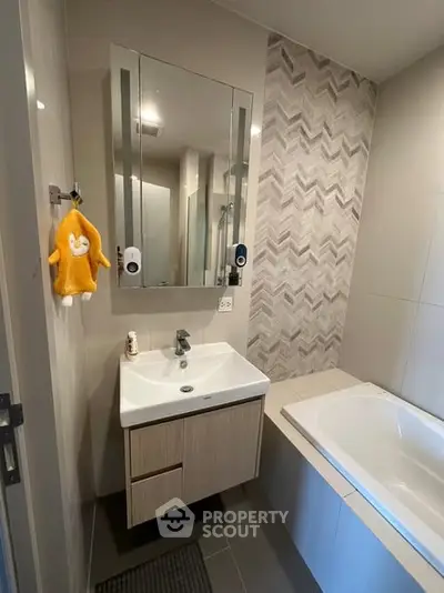 Modern bathroom with stylish vanity and bathtub in contemporary apartment