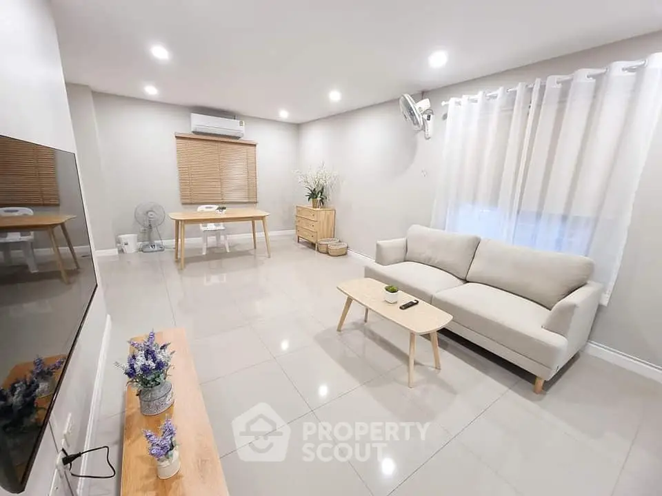 Spacious modern living room with sleek furniture and bright lighting