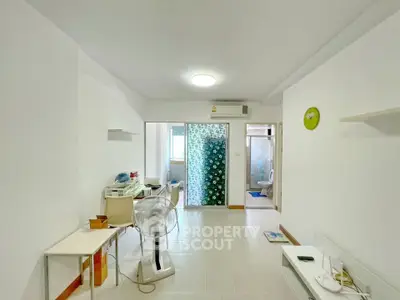 Spacious living area with modern decor and ample natural light