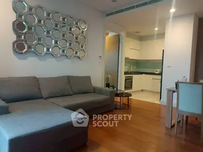 Modern living room with stylish decor and open kitchen layout in a contemporary apartment.