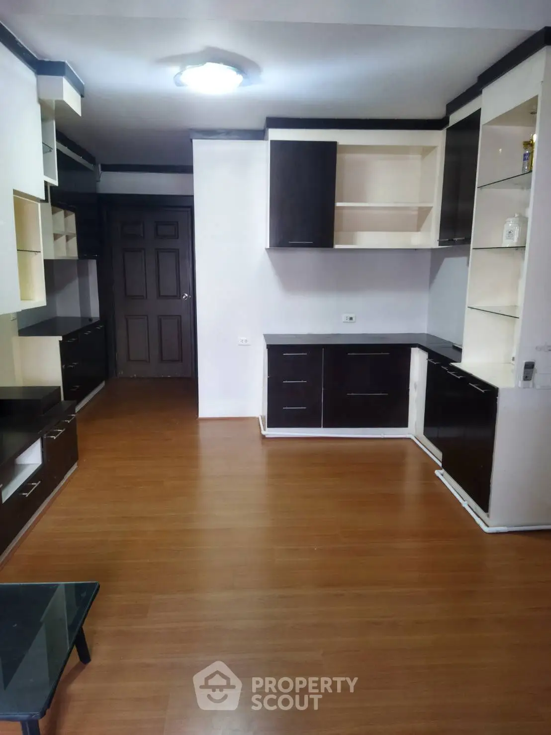Spacious living room with modern built-in cabinets and wooden flooring