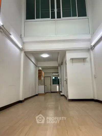 Spacious open-plan interior with high ceilings and modern design, perfect for versatile living arrangements.