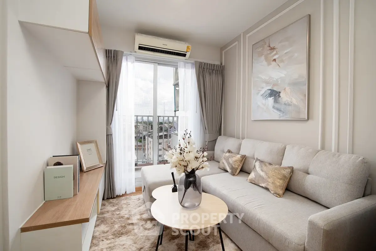 Modern living room with elegant decor, cozy sofa, and large window offering natural light and city view.