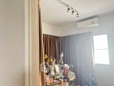 Cozy room with air conditioning and elegant curtains, perfect for a serene living space.