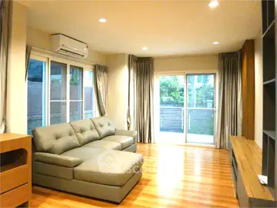 Spacious living room with modern sofa and large windows for natural light