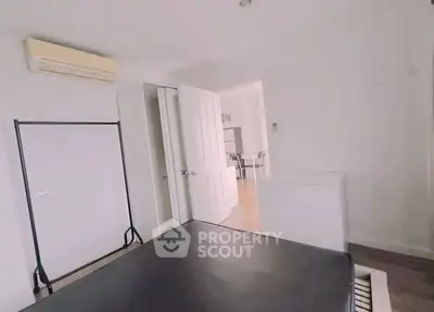 Spacious bedroom with modern furnishings and air conditioning in a bright apartment.