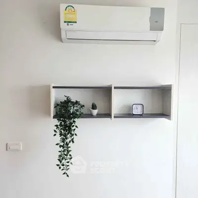 Modern interior with air conditioner and minimalist wall shelves.