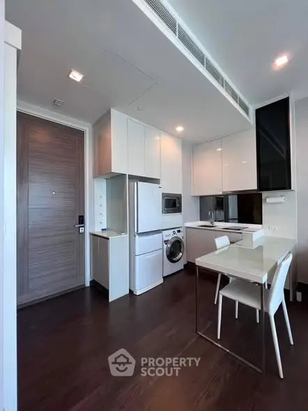 Modern kitchen with sleek appliances and dining area in a stylish apartment