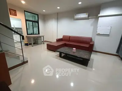 Spacious living room with modern sofa and sleek design, perfect for relaxation and entertaining.