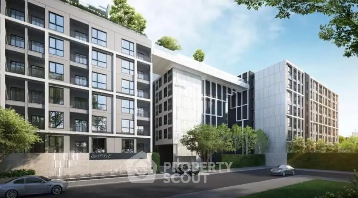 Modern apartment building with sleek design and lush greenery in urban setting.