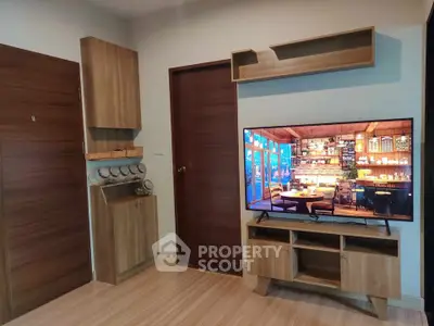 Modern living room with wooden furniture and large flat-screen TV