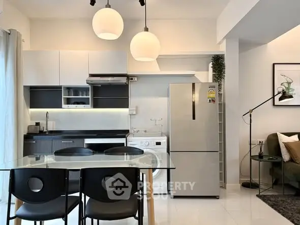 Modern kitchen and dining area with sleek appliances and stylish decor