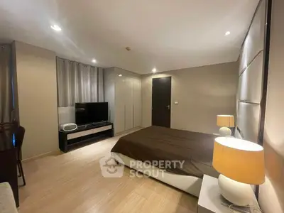 Spacious modern bedroom with sleek design and ambient lighting