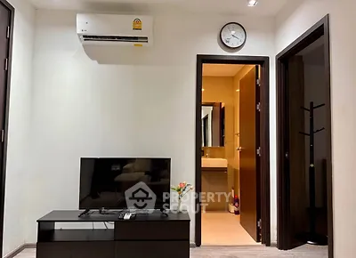 Modern living room with TV, air conditioning, and bathroom view