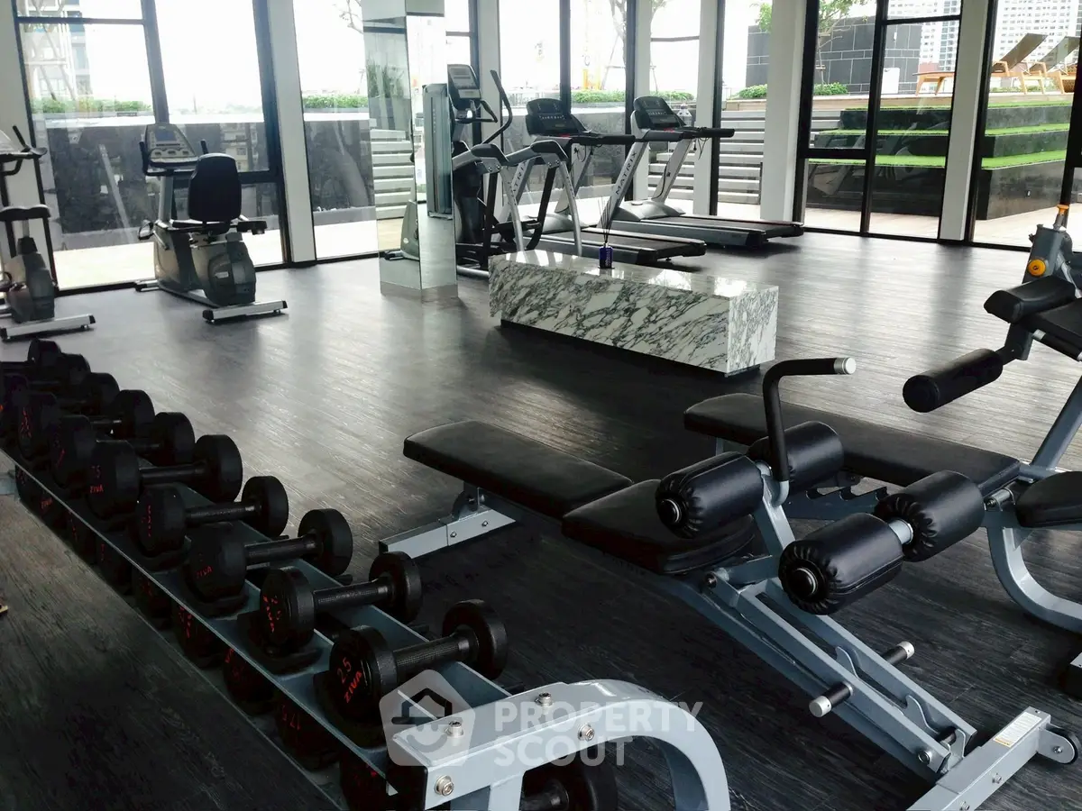 Modern gym with state-of-the-art equipment and panoramic city views.