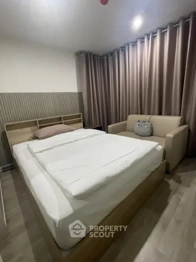 Cozy bedroom with modern decor and comfortable seating area