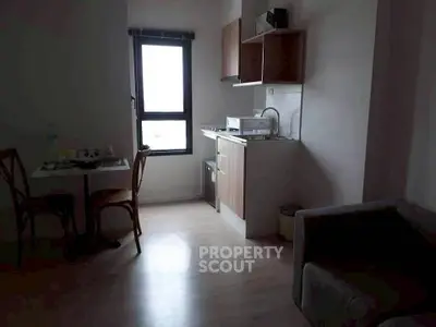 Cozy apartment interior with compact kitchen and dining area, perfect for urban living.