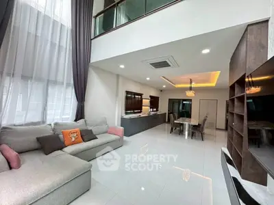 Spacious modern living room with high ceilings and elegant decor in a luxury apartment.