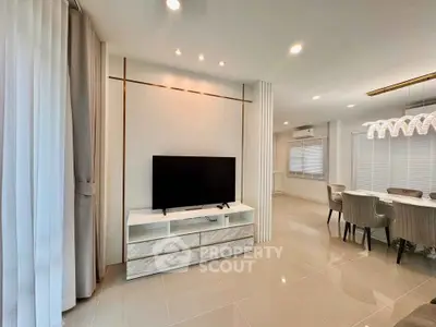 Modern living room with sleek TV stand and elegant dining area
