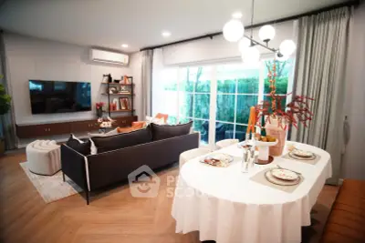 Elegant living room with modern decor, large windows, and stylish dining area, perfect for entertaining.