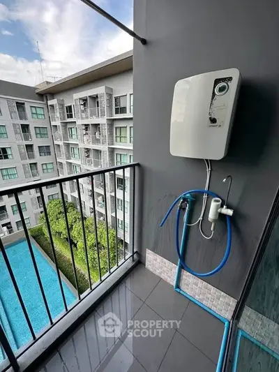 Modern balcony with pool view in urban apartment complex
