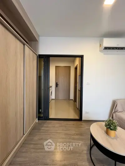 Modern living room with wooden flooring and sliding wardrobe doors