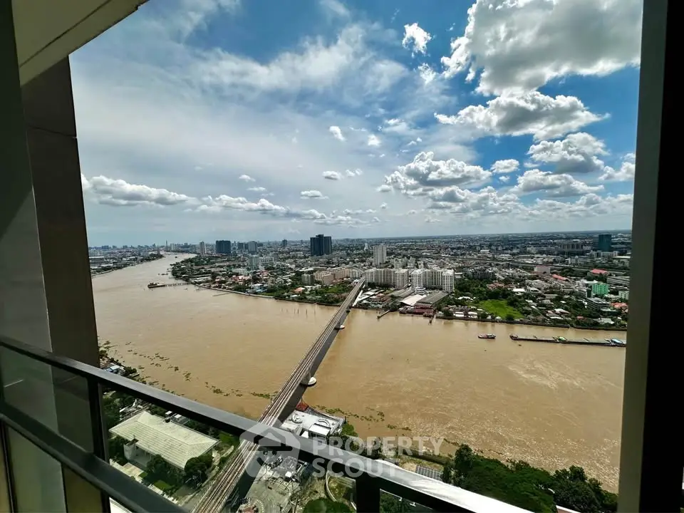 Stunning river view from high-rise balcony with cityscape and blue sky
