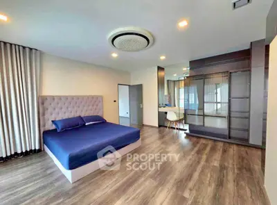 Spacious modern bedroom with elegant decor and ample natural light