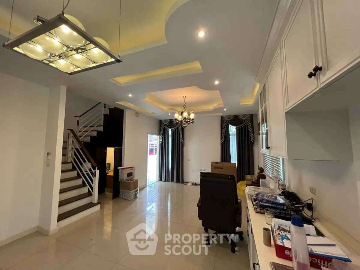 Spacious modern living room with elegant ceiling lights and stylish staircase