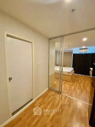 Modern bedroom with wooden flooring and sliding glass doors