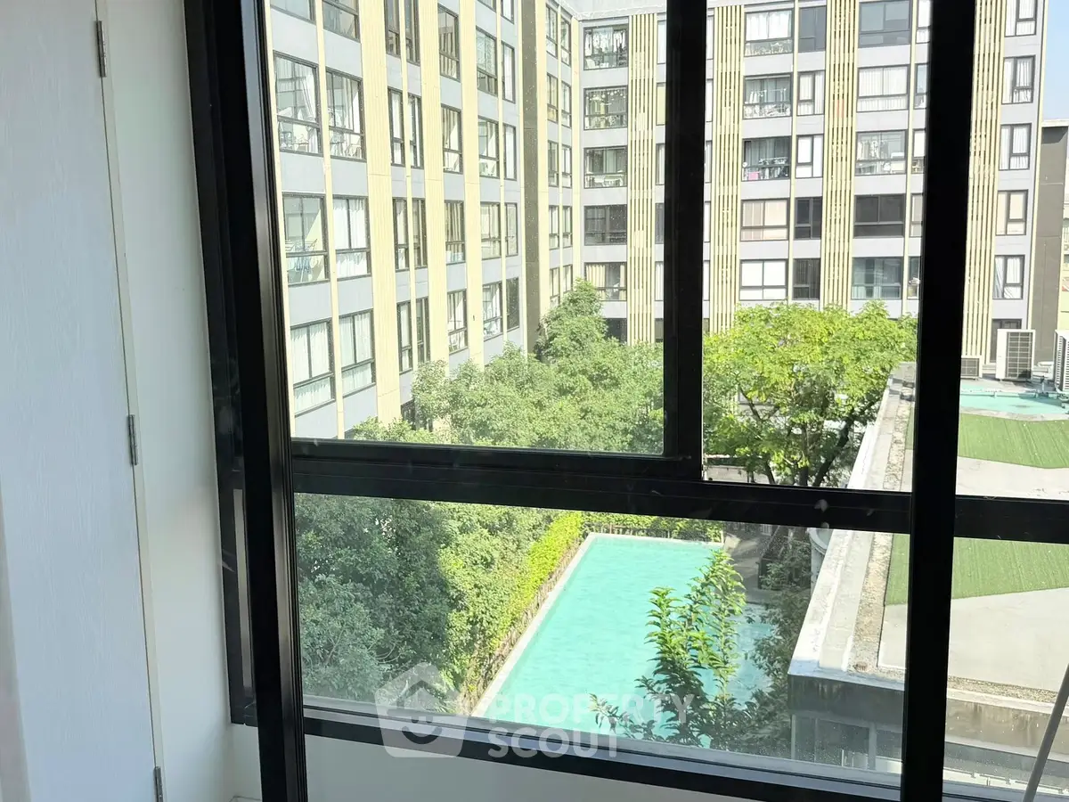 Spacious apartment with stunning pool view and lush greenery, perfect for urban living.