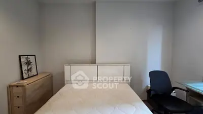 Cozy bedroom with modern furniture and comfortable bed in a minimalist design.