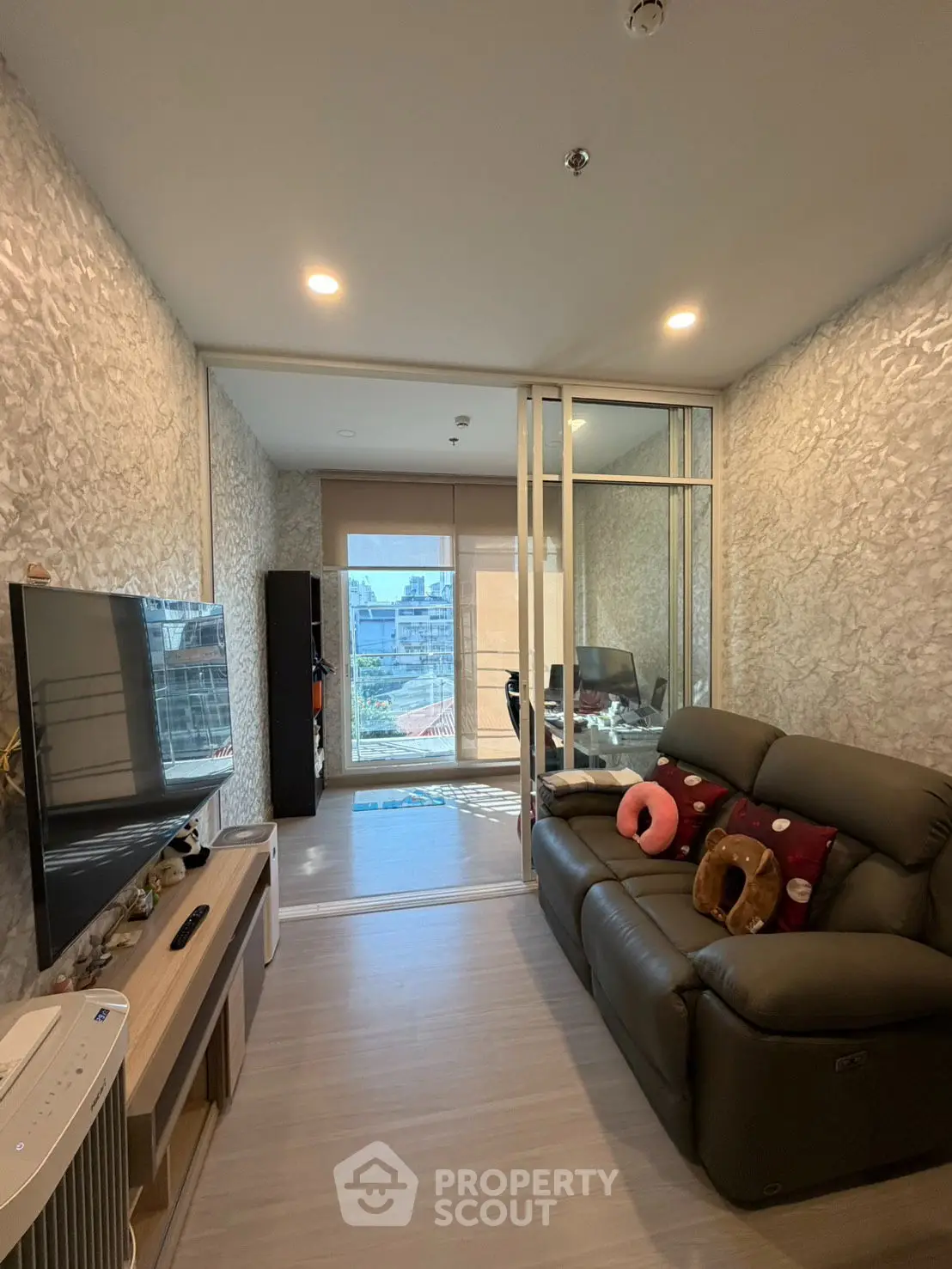 Spacious modern living room with stylish decor and comfortable seating.