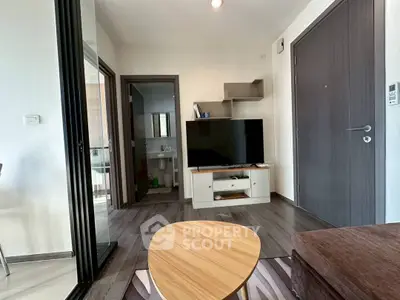 Modern living room with sleek TV setup and stylish wooden furniture.