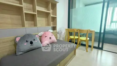 Charming small living room with cozy seating and playful decor in modern apartment.