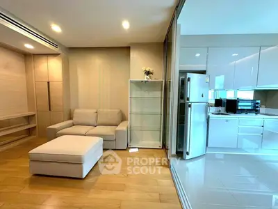 Modern open-layout living room with sleek kitchen and cozy seating area