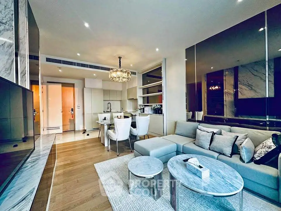 Luxurious modern living room with open kitchen, elegant decor, and stylish furniture in a high-end apartment.