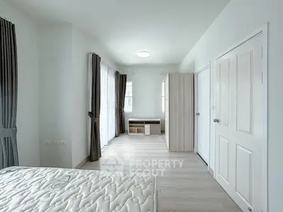 Spacious bedroom with modern design and ample natural light