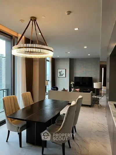 Luxurious open-plan living and dining area with elegant chandelier and city view.