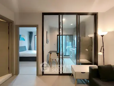 Modern apartment interior with glass partition, cozy living area, and stylish bedroom view.