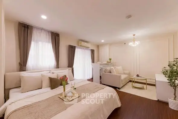 Luxurious bedroom with elegant decor and cozy seating area, perfect for relaxation.