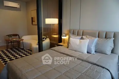 Modern bedroom with cozy seating area and stylish decor