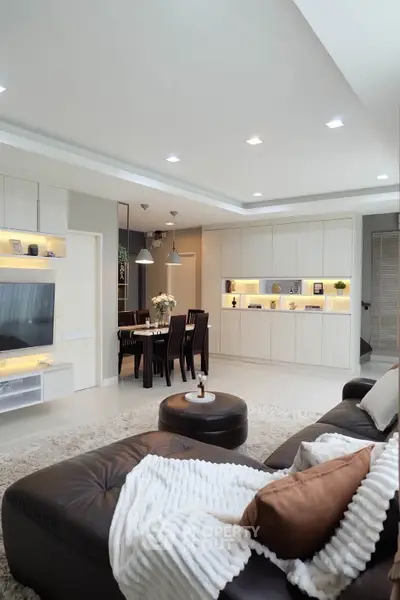 Spacious modern living room with cozy seating and elegant dining area, perfect for family gatherings.