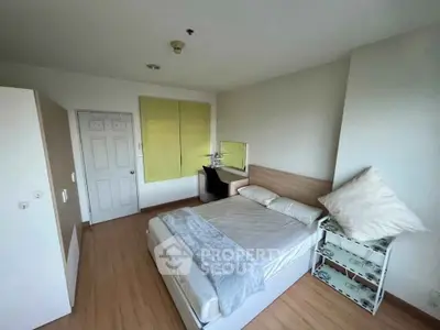 Cozy bedroom with modern furnishings and ample natural light, perfect for relaxation and comfort.