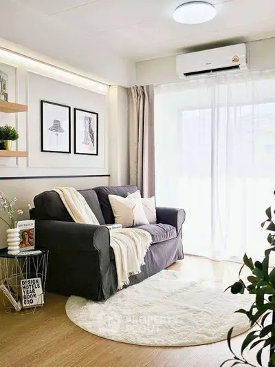 Chic living room with cozy sofa, modern decor, and natural light.