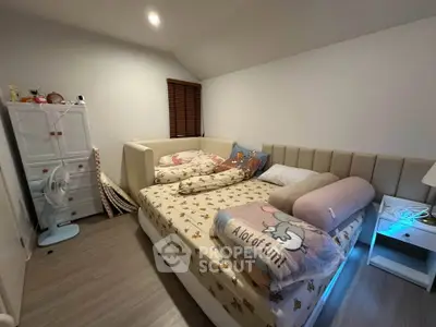 Cozy bedroom with stylish bed and modern decor, perfect for relaxation.