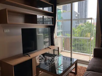 Modern living room with TV and balcony view in urban apartment