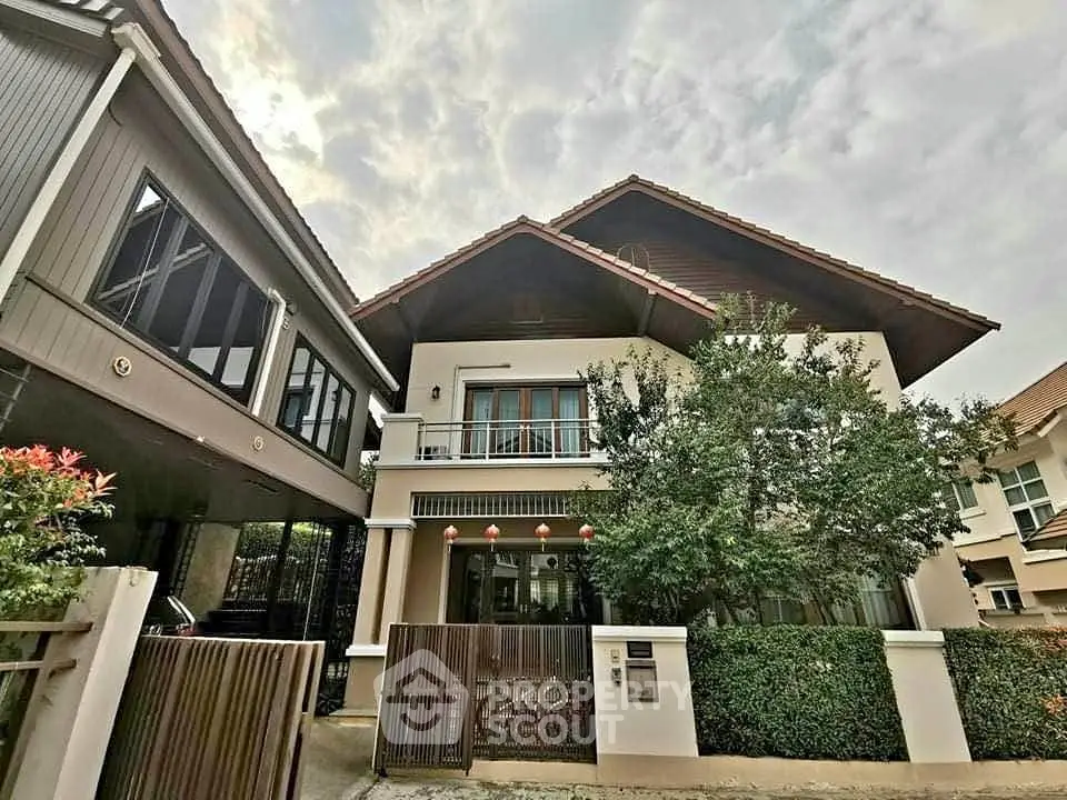 Charming two-story house with lush greenery and modern design in a serene neighborhood.